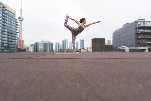woman doing yoga in urban setting
