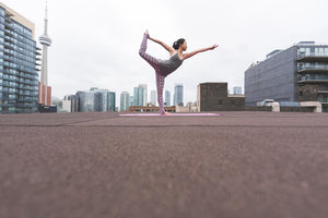 woman doing yoga in urban setting